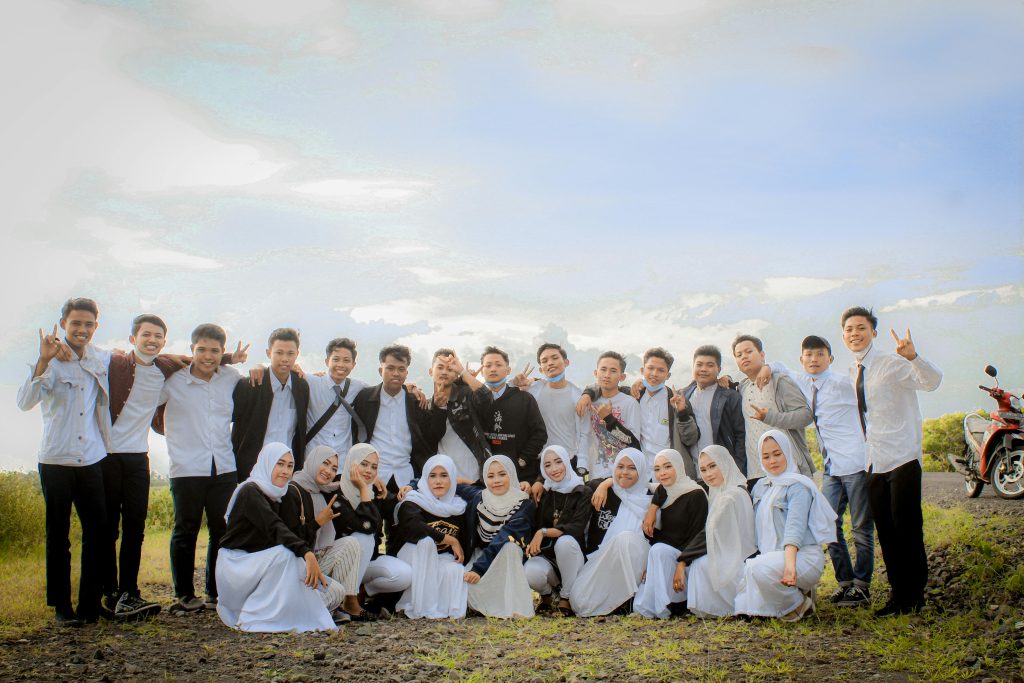 Large group of young adults posing together outdoors in East Java, Indonesia.