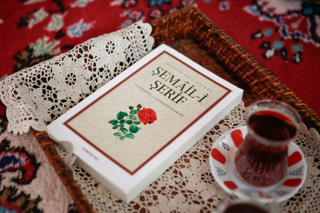 A cozy arrangement featuring Turkish tea and a classical book in a decorative setting.