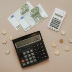 Flat lay of calculators and Euro currency, depicting financial calculations and budget management.