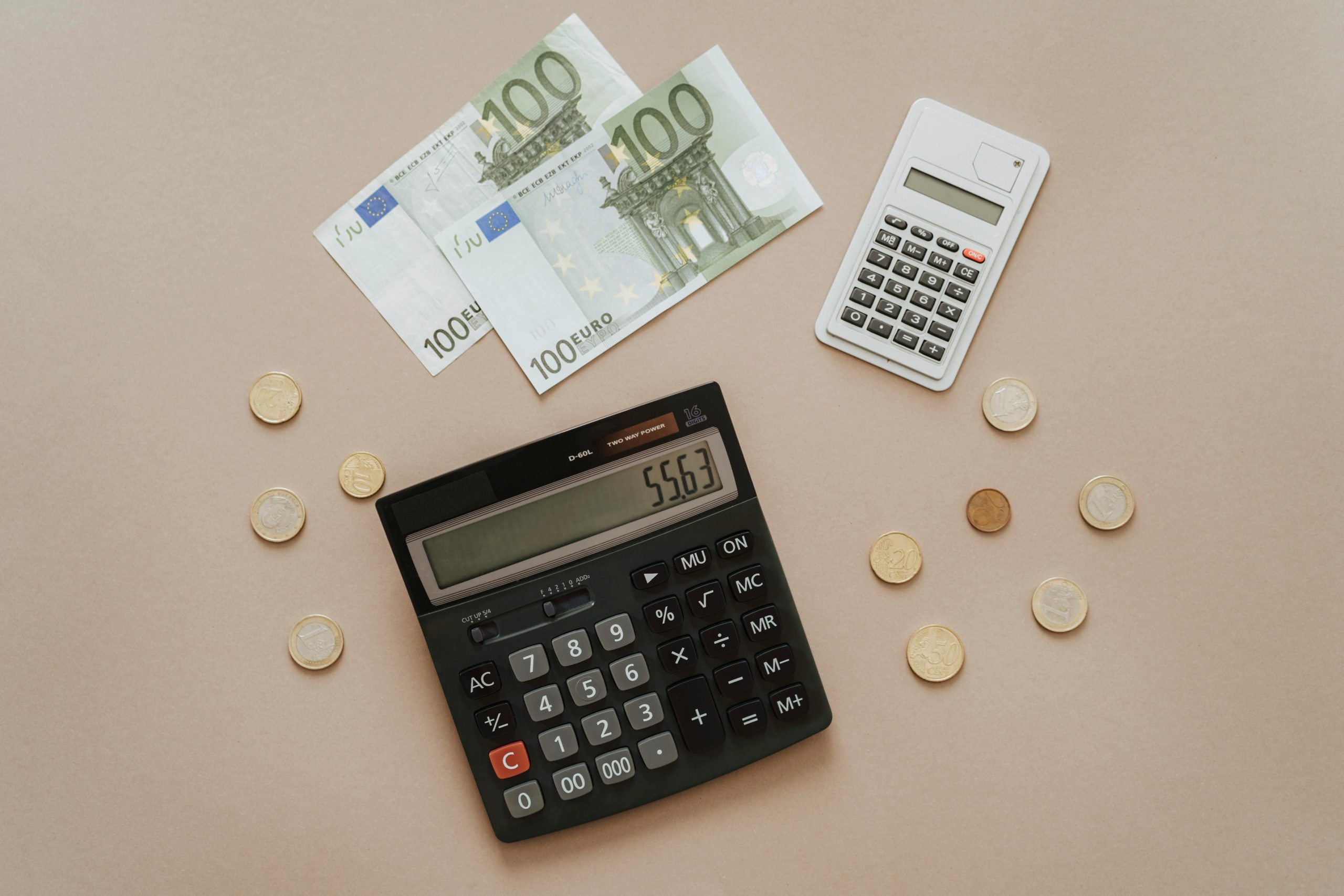 Flat lay of calculators and Euro currency, depicting financial calculations and budget management.