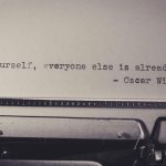 Vintage typewriter displaying Oscar Wilde's quote 'Be yourself, everyone else is already taken.'