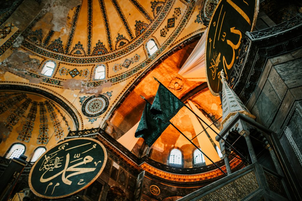 From below of aged ornamental dome with arched windows in Hagia Sophia Mosque in Istanbul