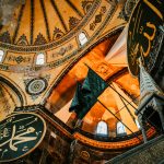From below of aged ornamental dome with arched windows in Hagia Sophia Mosque in Istanbul