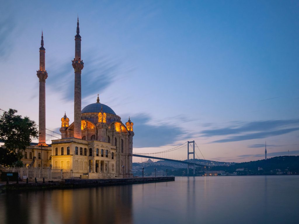 A stunning view of Ortaköy Mosque with Bosphorus Bridge at twilight in Istanbul, Turkey.
