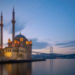 A stunning view of Ortaköy Mosque with Bosphorus Bridge at twilight in Istanbul, Turkey.
