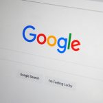 Close-up of the Google homepage on a screen showing search options.