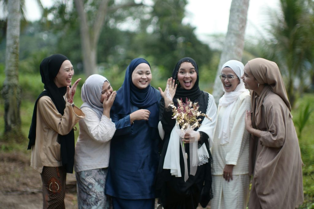 A cheerful group of women celebrating an engagement in Alor Gajah, Malaysia, showcasing unity and happiness.