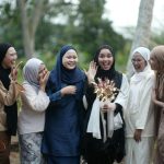 A cheerful group of women celebrating an engagement in Alor Gajah, Malaysia, showcasing unity and happiness.