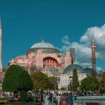 Beautiful view of Hagia Sophia surrounded by lush greenery and blue sky.