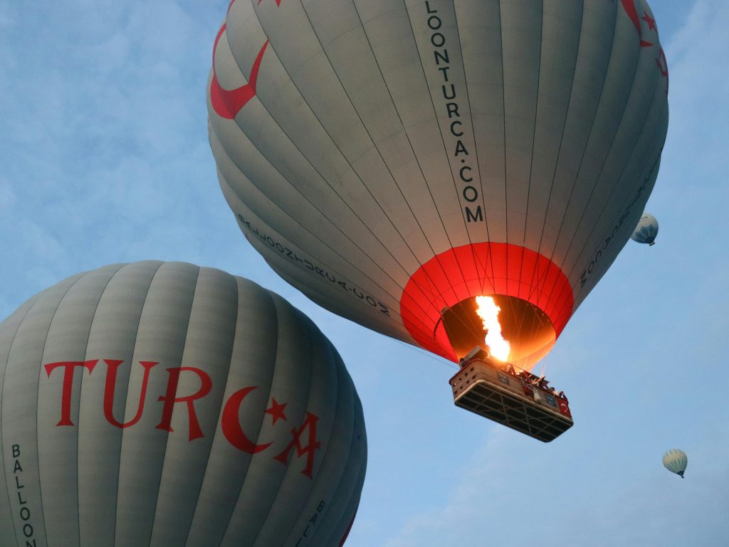 Hot air balloons flying in an early morning sky, showcasing adventure and travel.