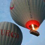 Hot air balloons flying in an early morning sky, showcasing adventure and travel.