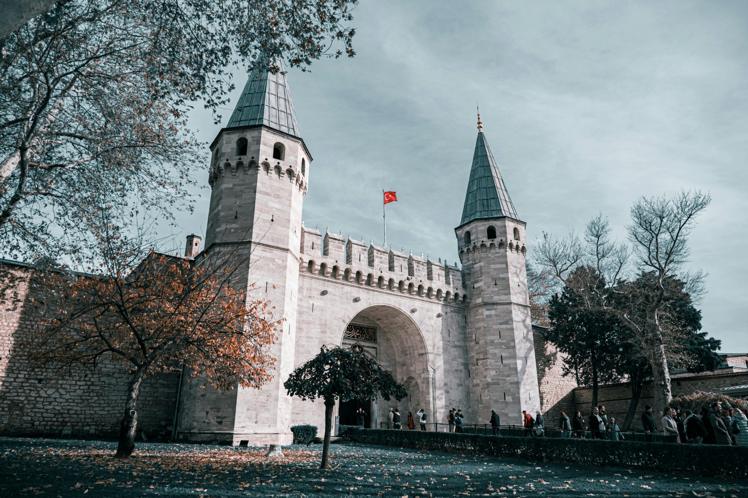 Historic entrance of Topkapı Palace captured during autumn in Istanbul.