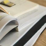 A pile of open books on a table, ideal for study and research themes.