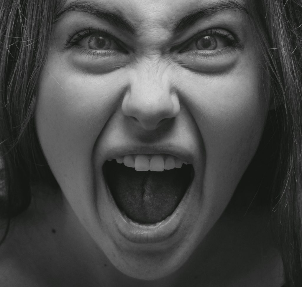 Dramatic grayscale portrait capturing a woman's intense facial expression in Kyiv.