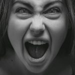 Dramatic grayscale portrait capturing a woman's intense facial expression in Kyiv.